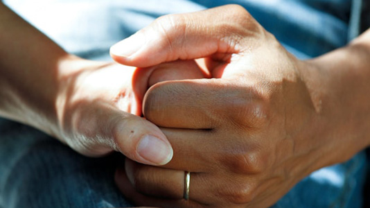 Two people holding hands