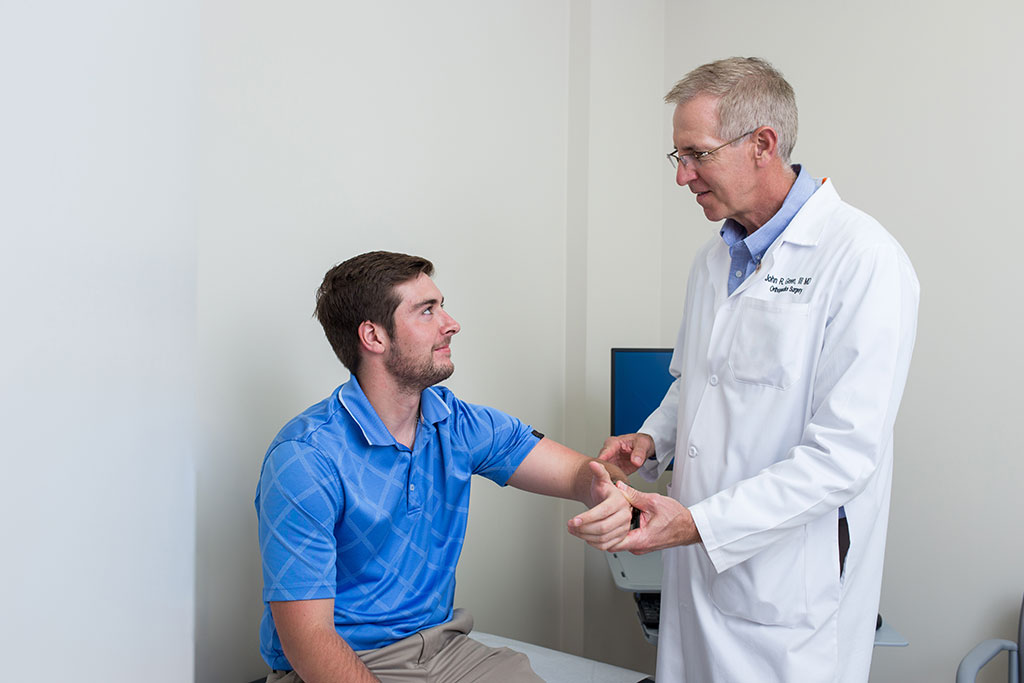 a doctor examining a patient's arm