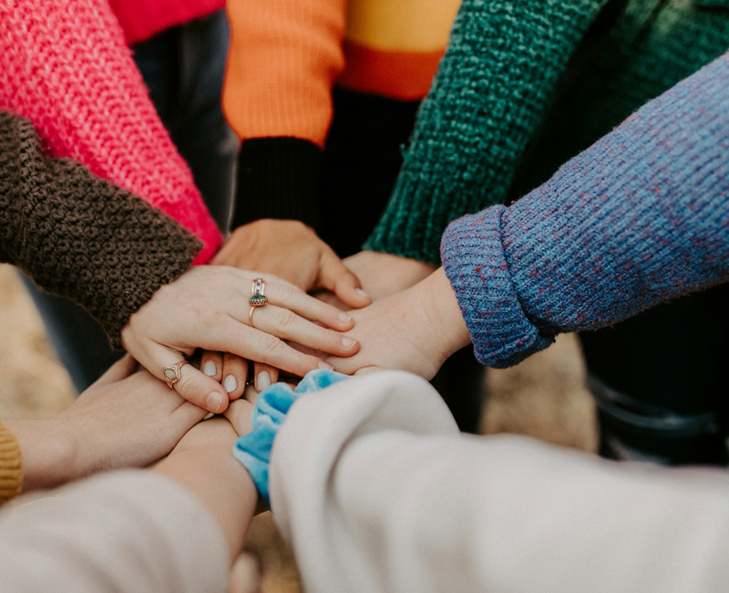 Group of people stacking hands