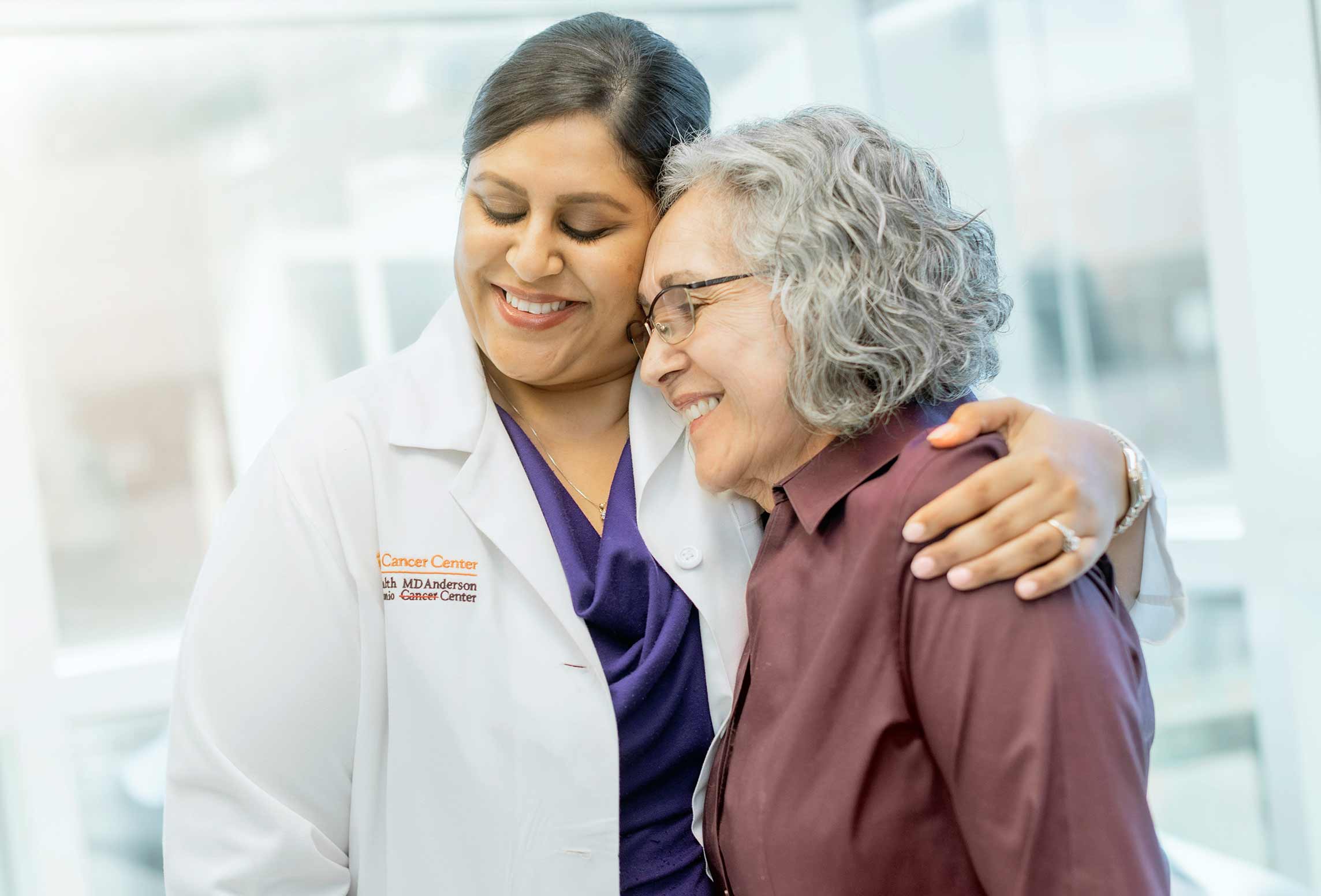 doctor embracing elderly patient